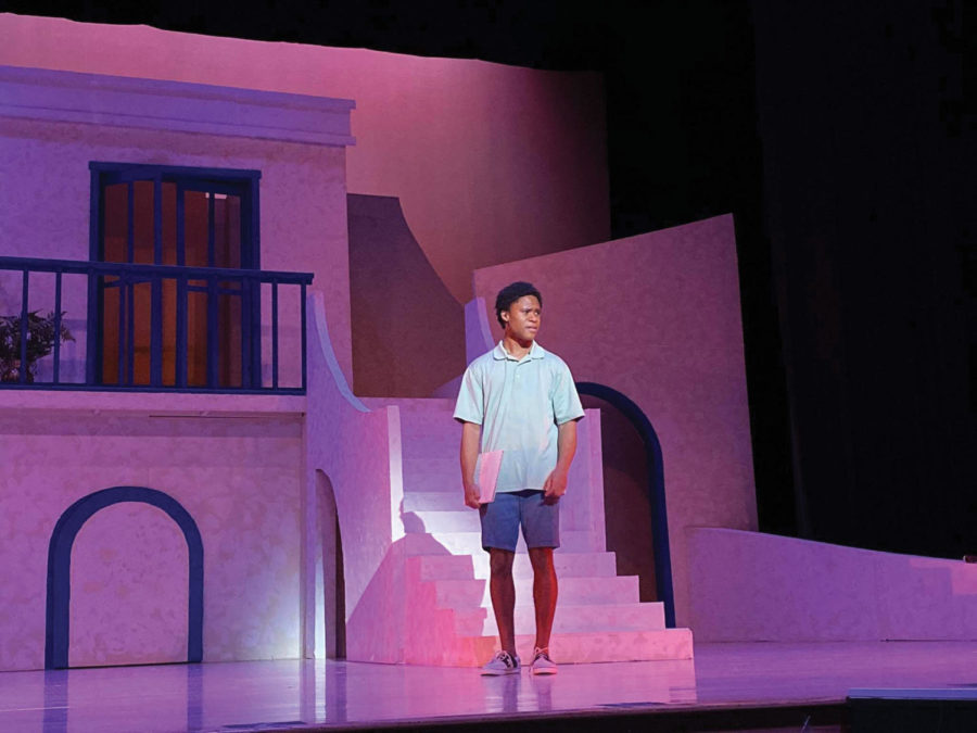 Miles stands on the stage during a performance in Mamma Mia.