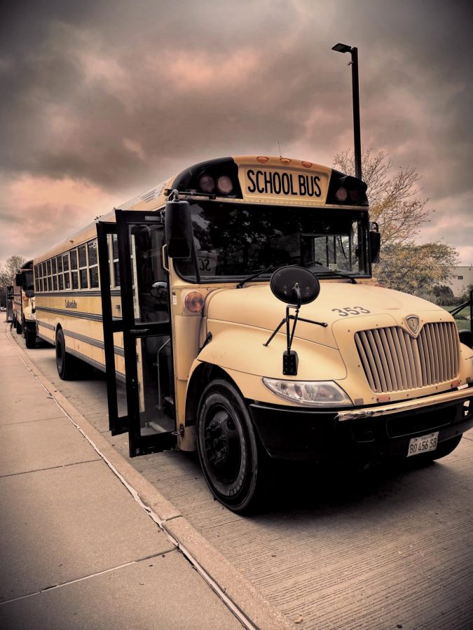 A filtered image of a bus waiting for students to get on.