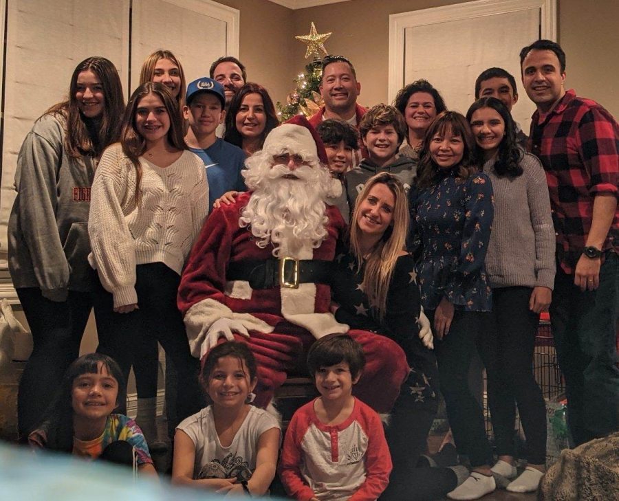 This photo shows Frannie Poulos and her extended family members spending time together with santa.