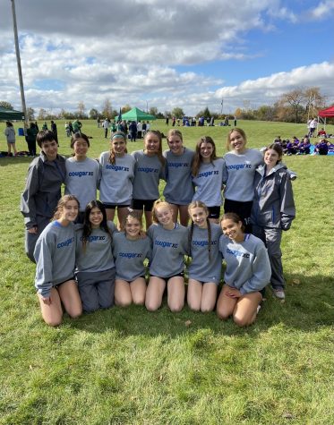 The girls cross country team poses for a picture.