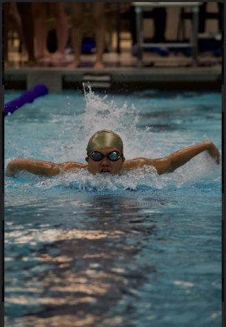 Boy tries to swim quickly through laps.