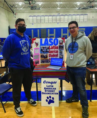 Orlando Alas and Daniel Santiago stand beside the LASO poster at the Unity Fair.