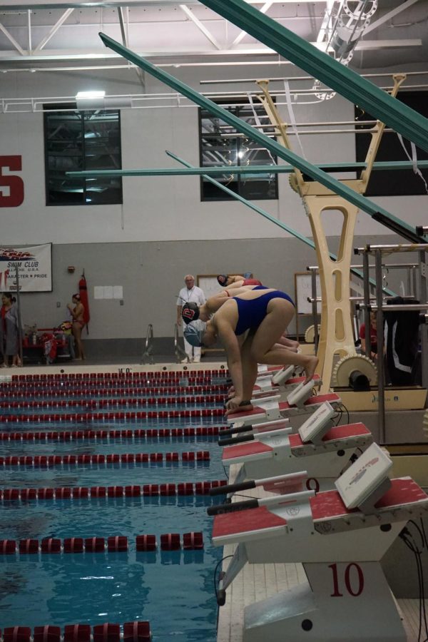 Marge Zywickis (11) is ready to dive off and lead cougars in first event of the night.