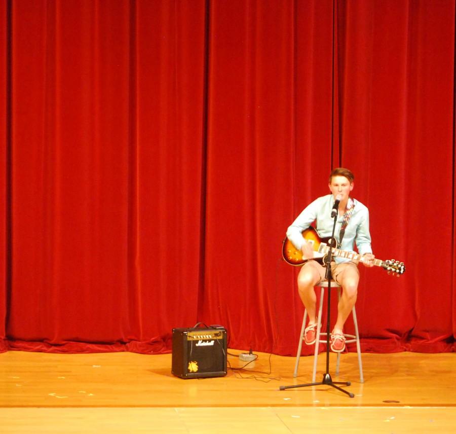 Tyler Smith plays the guitar during his talent portion.