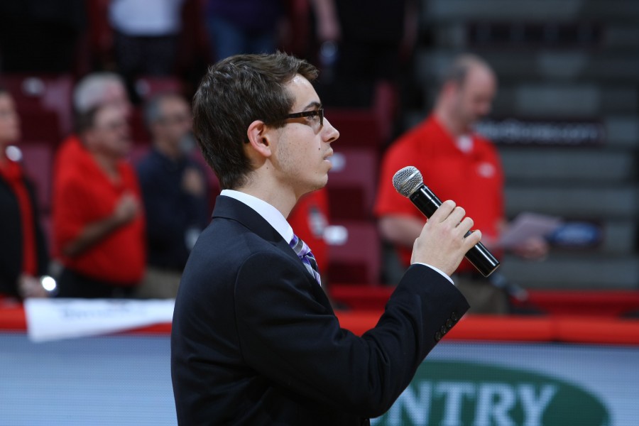 Zac Kurzenberger (12) sings the national anthem at the volleyball state finals.