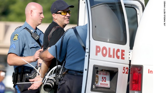 Photojournalist being arrest for covering Ferguson protest. 