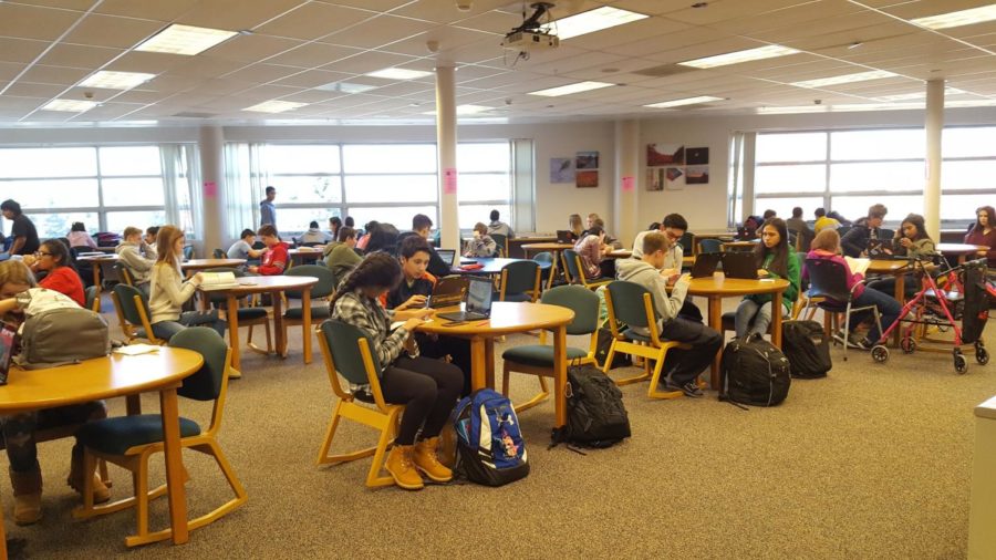 Freshmen silently working in the crowded study hall