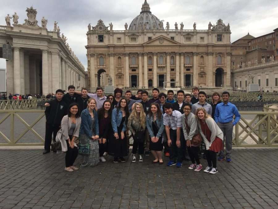 This is a picture of the band members from the 2017 Spring Break trip. They are posing for a group picture in front of some buildings in Italy.