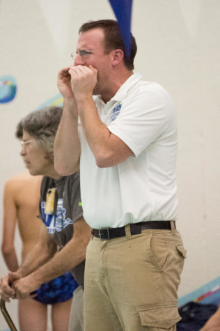 Head Boys Swim Coach Lueken cheers on his swimmers