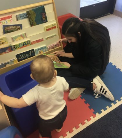 Ruth Damianov reads books to the toddlers at Condell Child Day Center.