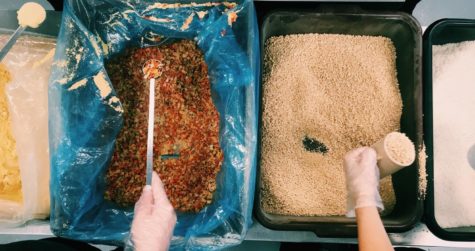 Students scoop soy and dried vegetables.