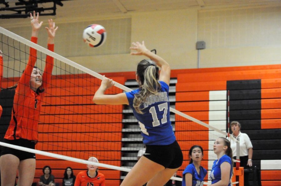 Victoria Lukyan hits the volleyball over the net.