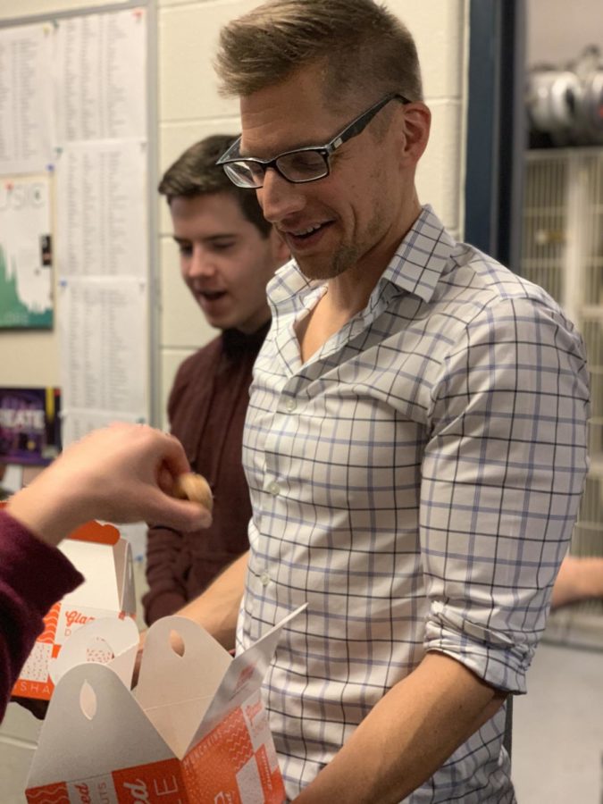 Mr. Green handing out donut holes for his students.
