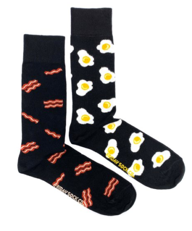 A pair of socks, one with bacon on it and one with eggs.