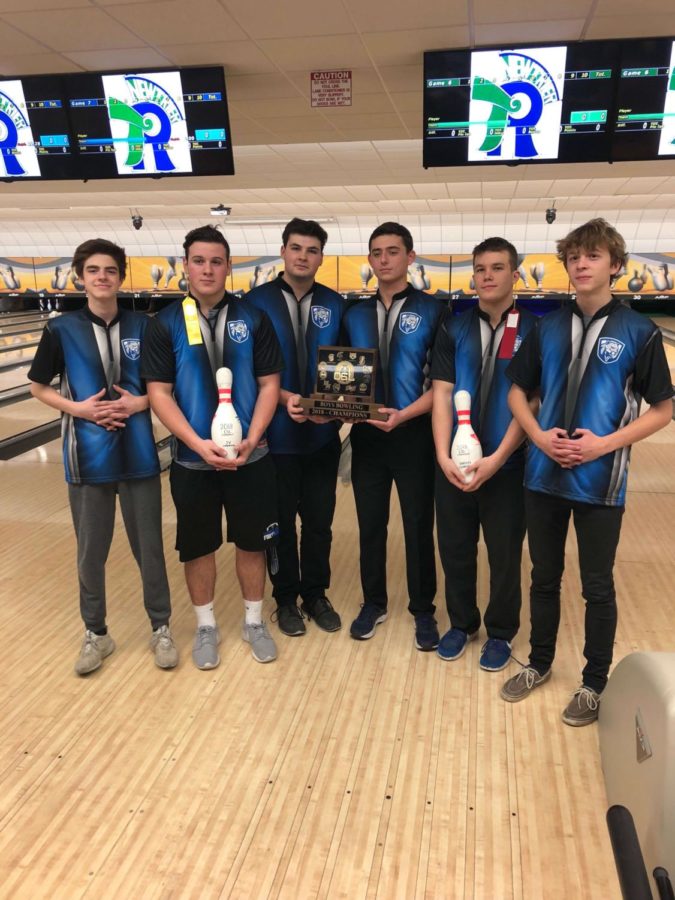 Members of the bowling team holding their conference trophy