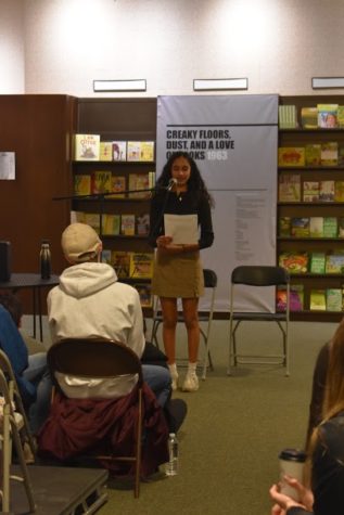 This is an image of Sneha Akurati (12) reading her Social Justice Literature essay about accepting her race.