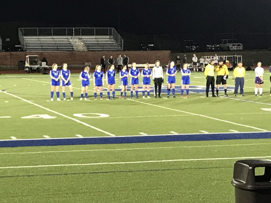 The starting 11 players are standing in a line as they always do for the national anthem and to be introduced by the announcer.
