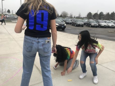 Seniors draw a picture on the ground