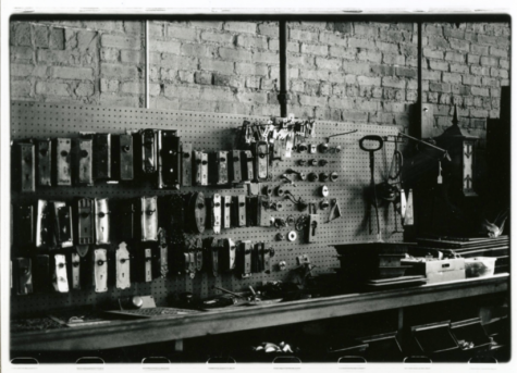 A black and white photo of a toolshed