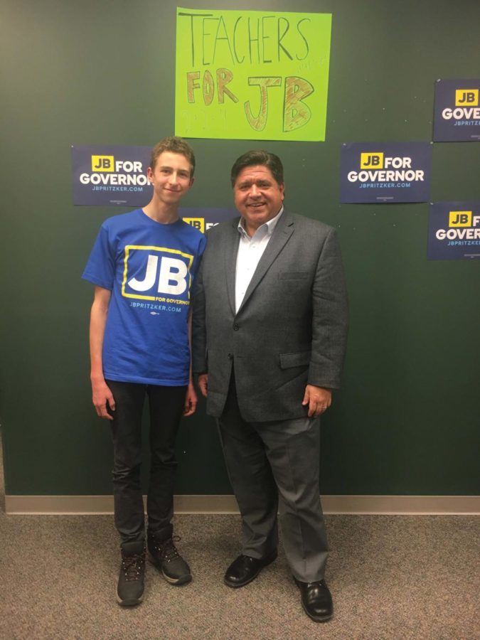 A VHHS student stands next to the Illinois Governor J.B Pritzker
