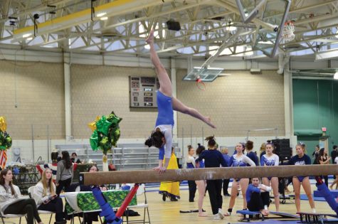 Becca Tran performs a backhandspring during a competion.