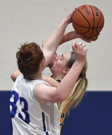  Grace Koepke goes up for an intense block.