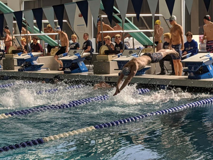 Jacob Schifrin explodes off his starting block into the water.