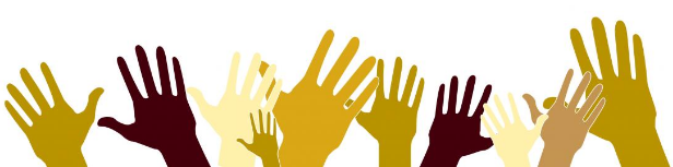 Image of hands with different skin tones raised in the air.
