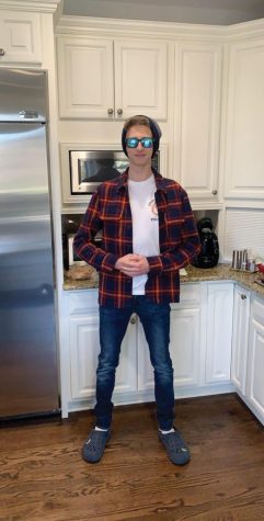 Zander poses in a flannel and jeans.