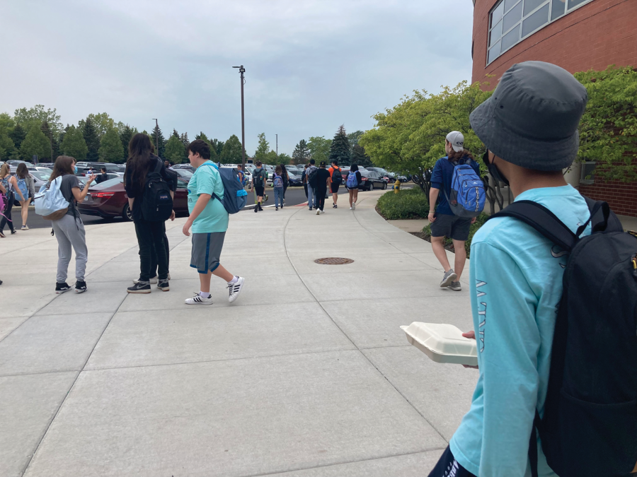 Students of all grades eagerly head out to the parking lot for lunch.