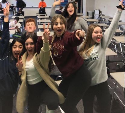 A group of students pose for the camera in freshman transition class.