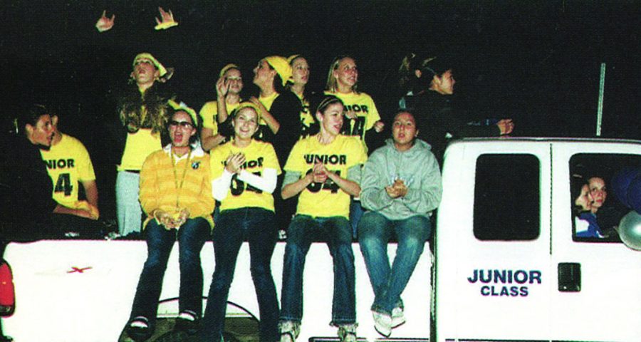 VHHS Juniors from 2002 sit cheering on a pickup truck during a homecoming parade