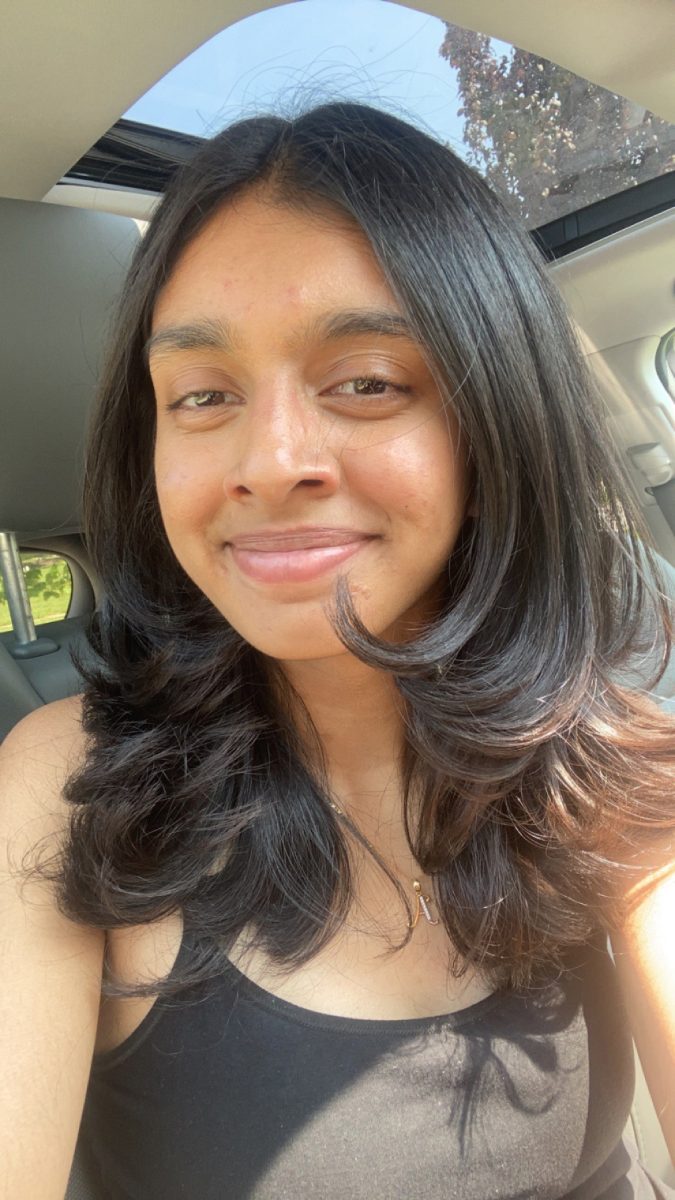 Aanya smiles in a car.