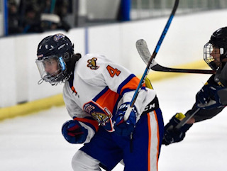 Wesley Engle slides for the puck while being chased by his opponent.