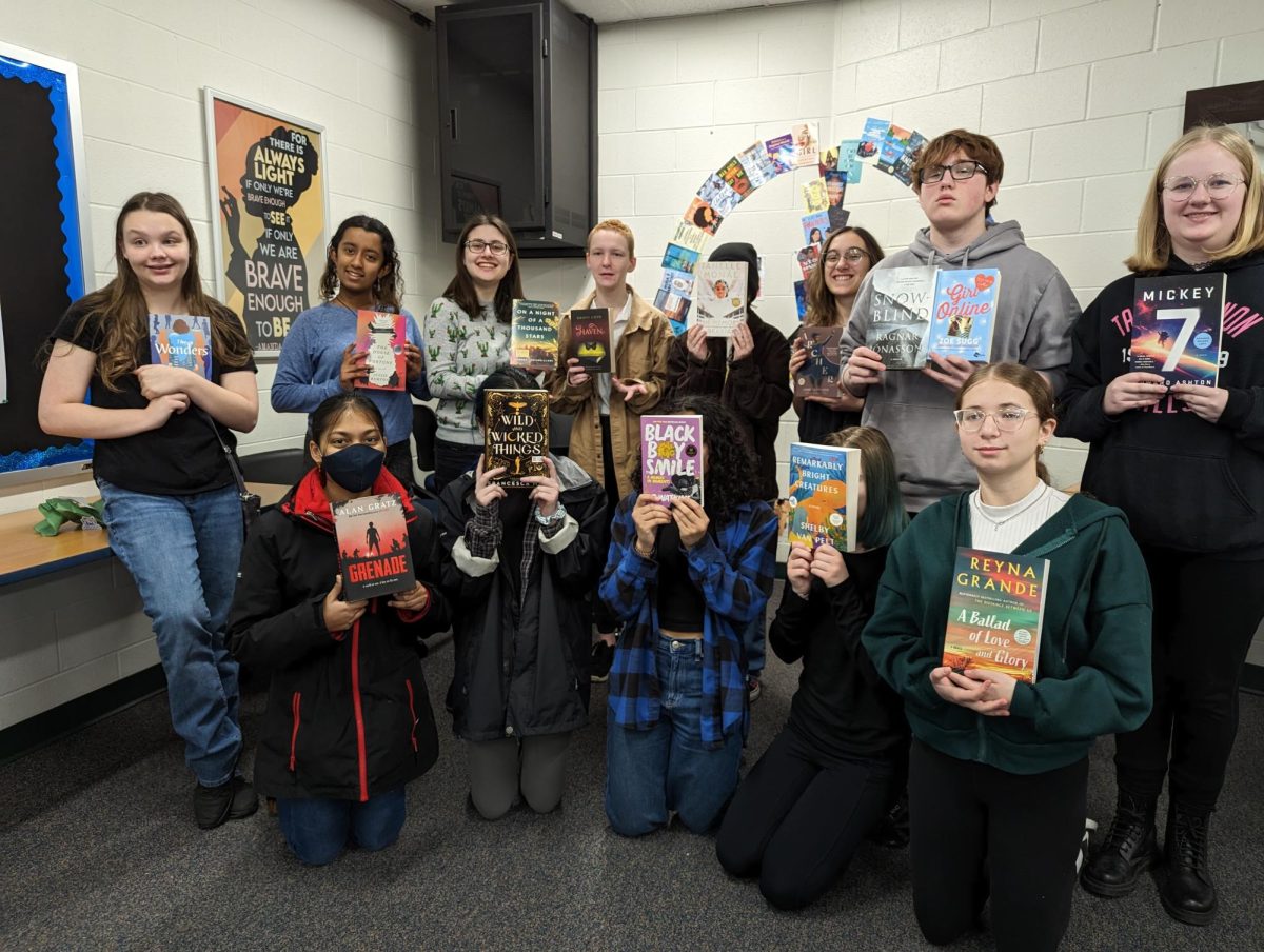 Starbook Club members pose with new books after book swap.