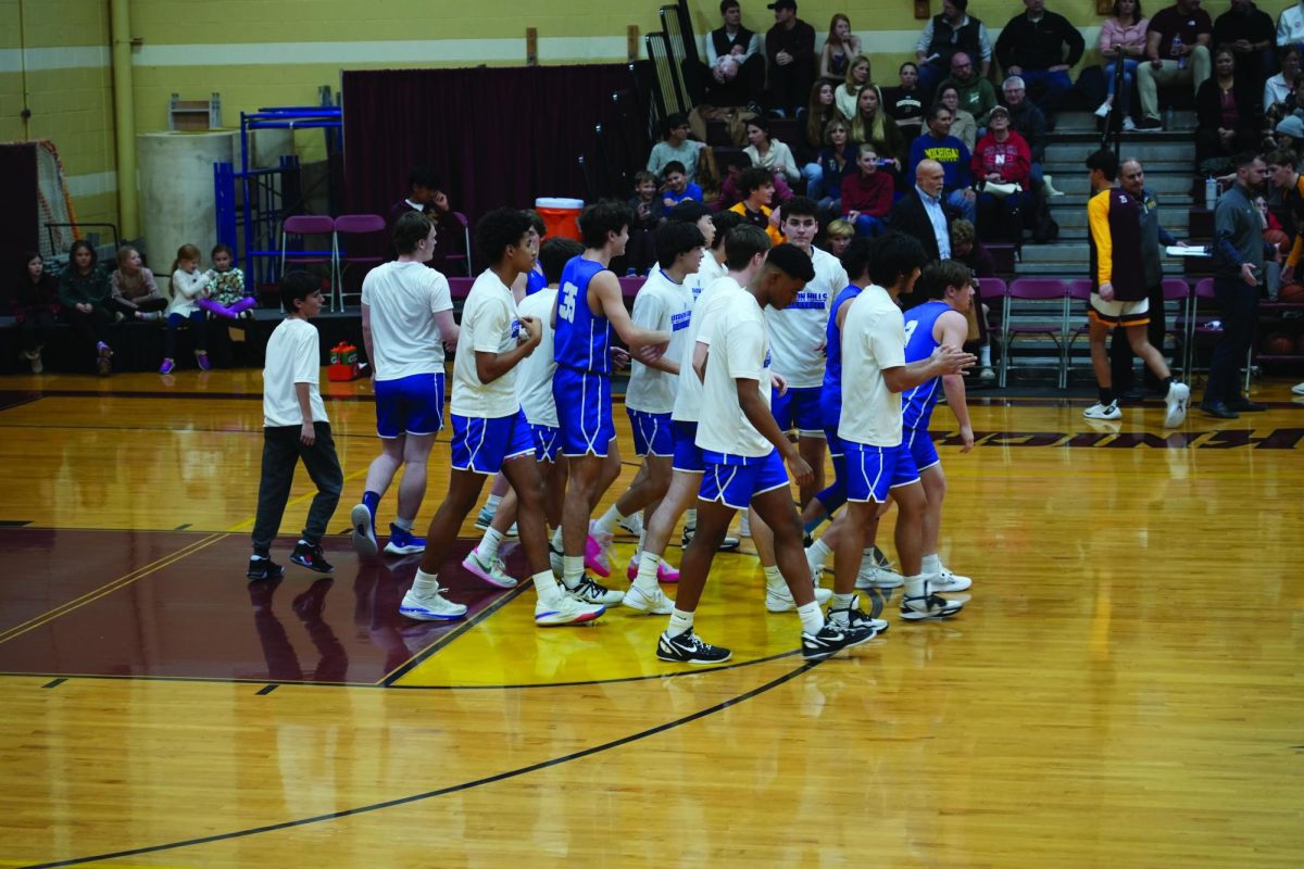 Boys’ Varsity basketball team walks onto the Carmel Catholic courts.
