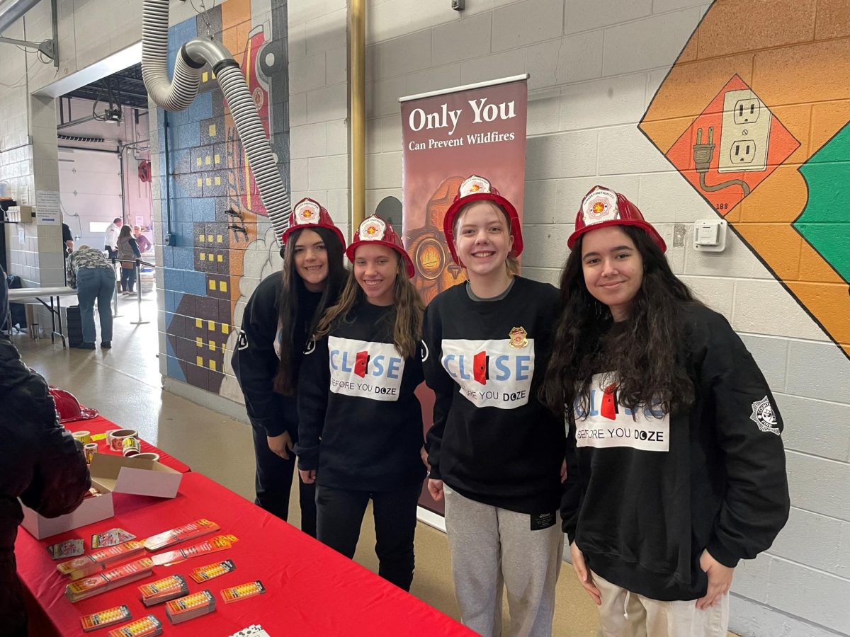 From left to right: Mia Vaca, Noelle Leja, Masha Razhkova, and I volunteer at the open house passing out informational packages.