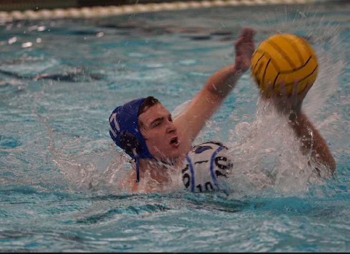 Emmitt looks to block a pass during a water polo match.