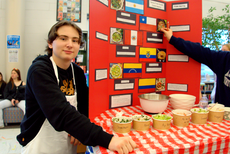 Michael Olson (11) poses with his homemade South American sauces.  