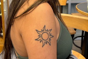 Amira Patel (12) shows off her sun tattoo. 