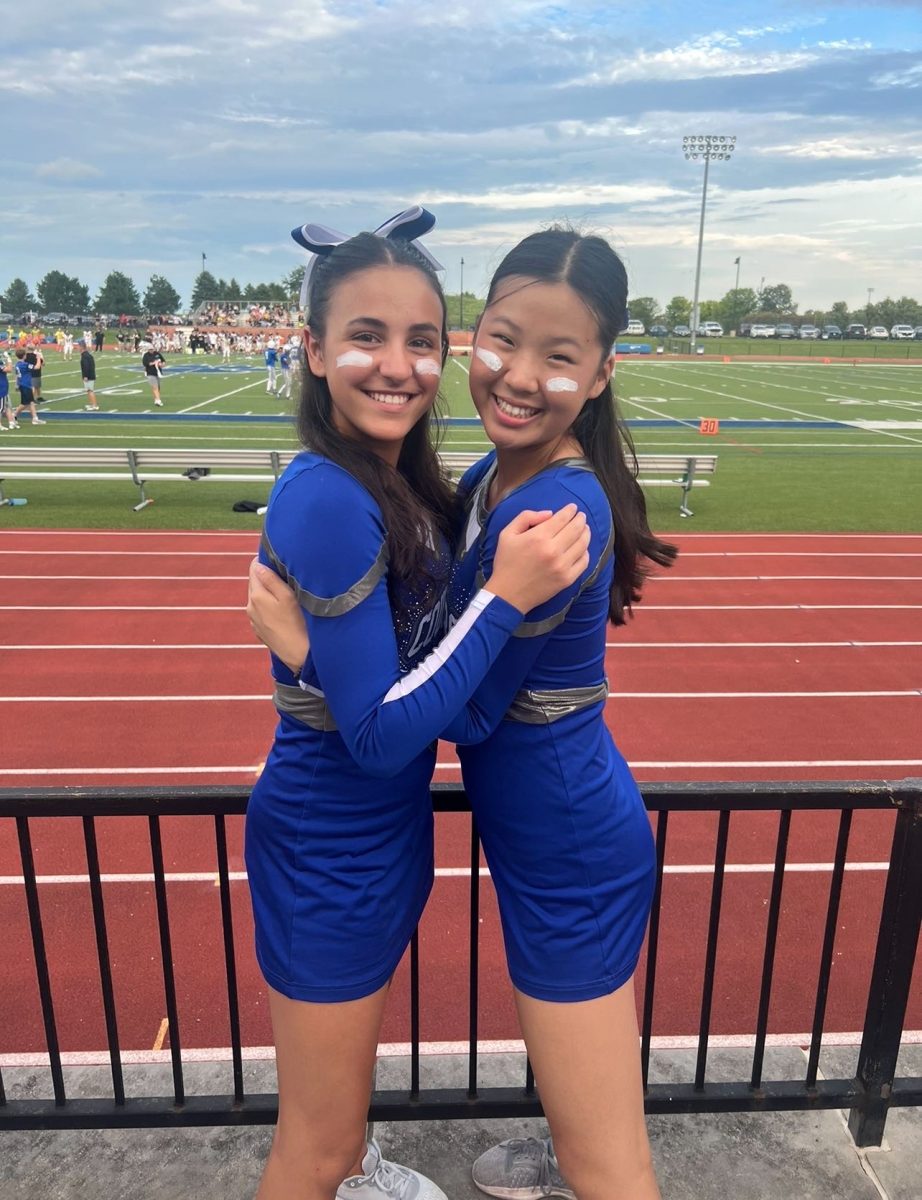 Students in cheer, Mia Psaras and Karis Choi pose for a picture during the first home football game of the season