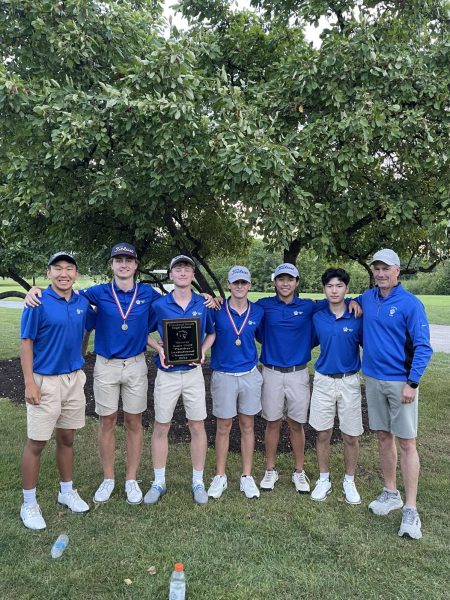 Conor Fayard and his teammates pose for a picture after receiving a plaque Glenbard North Invitational for golf.