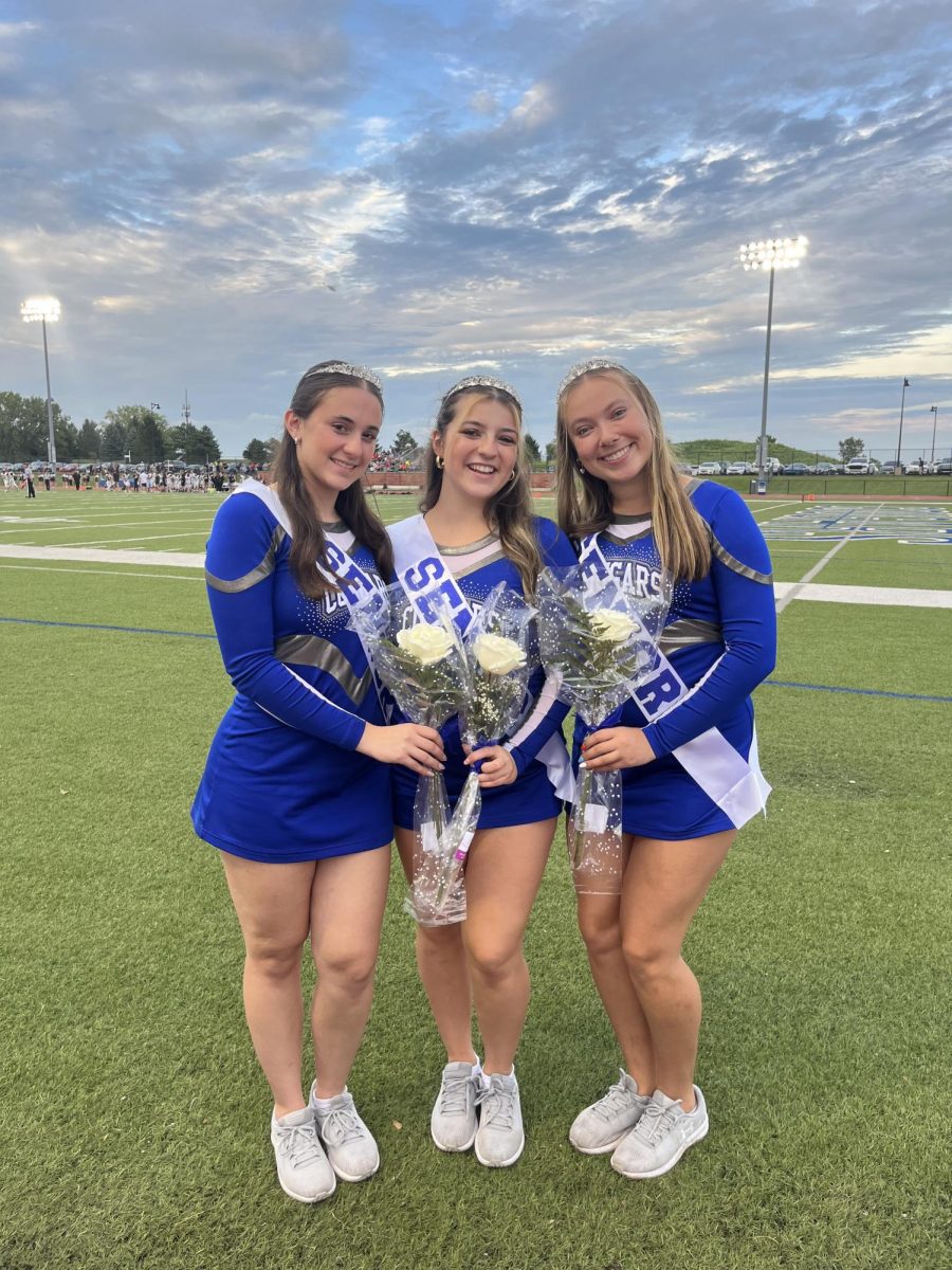 Students in cheer posing for a picture on senior night