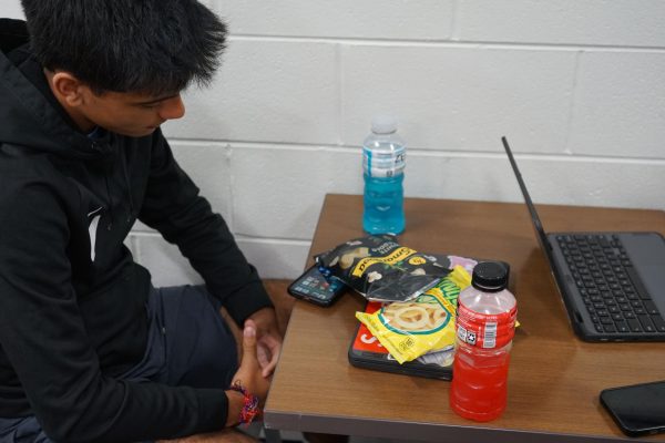 Devan Acharya (11) sitting in the UC and following new rules by not eating food. 