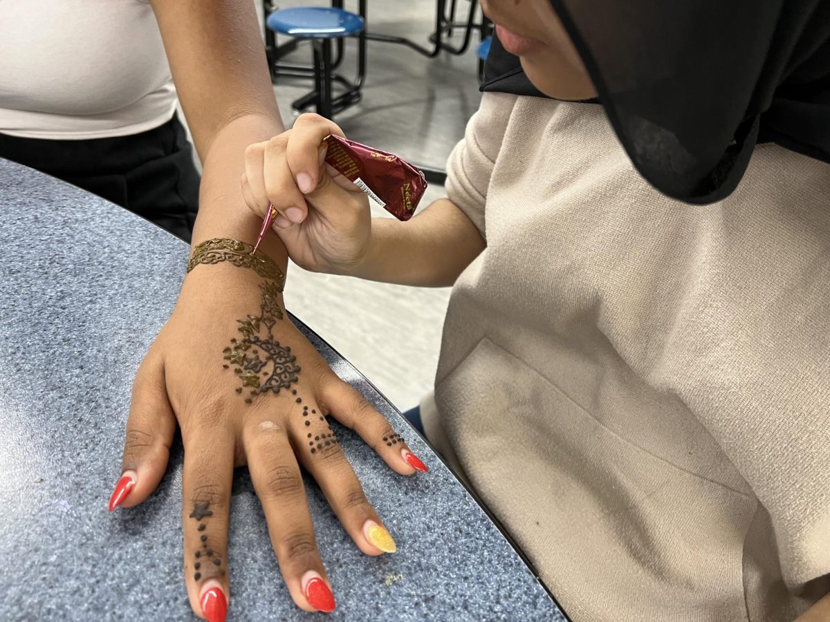 Manha Dayala (10) does mehndi, also known as henna tattoo, on Ananya Murli (12) as part of Indian Student Association’s celebration of Diwali.