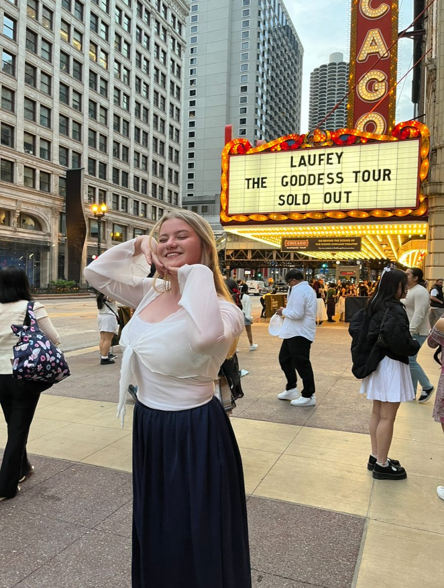 Violet smiles for the camera in front of a Chicago theater sign.