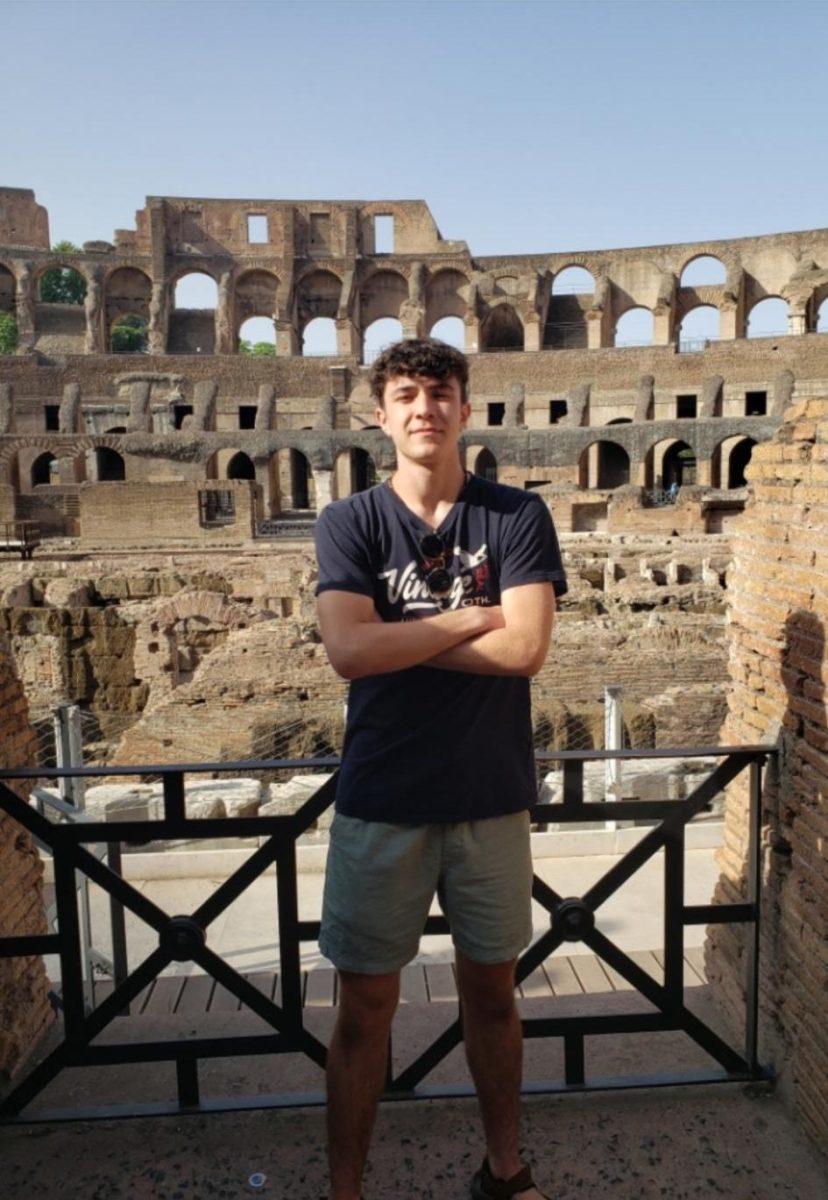 Tomasz stands in front of the colosseum.