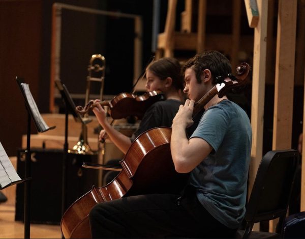 Tessa Stobart (12) and Caleb Gumminger (12) play their instruments to practice for “Hadestown: Teen Edition”.