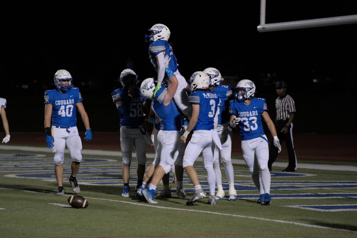 Giuseppe Urso (11) celebrates after scoring a touchdown on the Sept. 27th Homecoming game against Maine West.