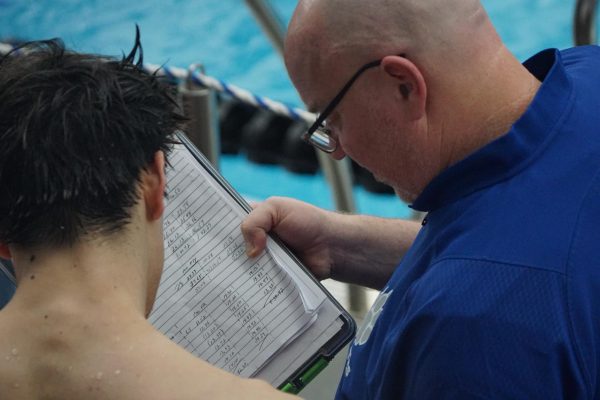 Jim Pardun and Edgar Chan (11) discuss splits following his races.